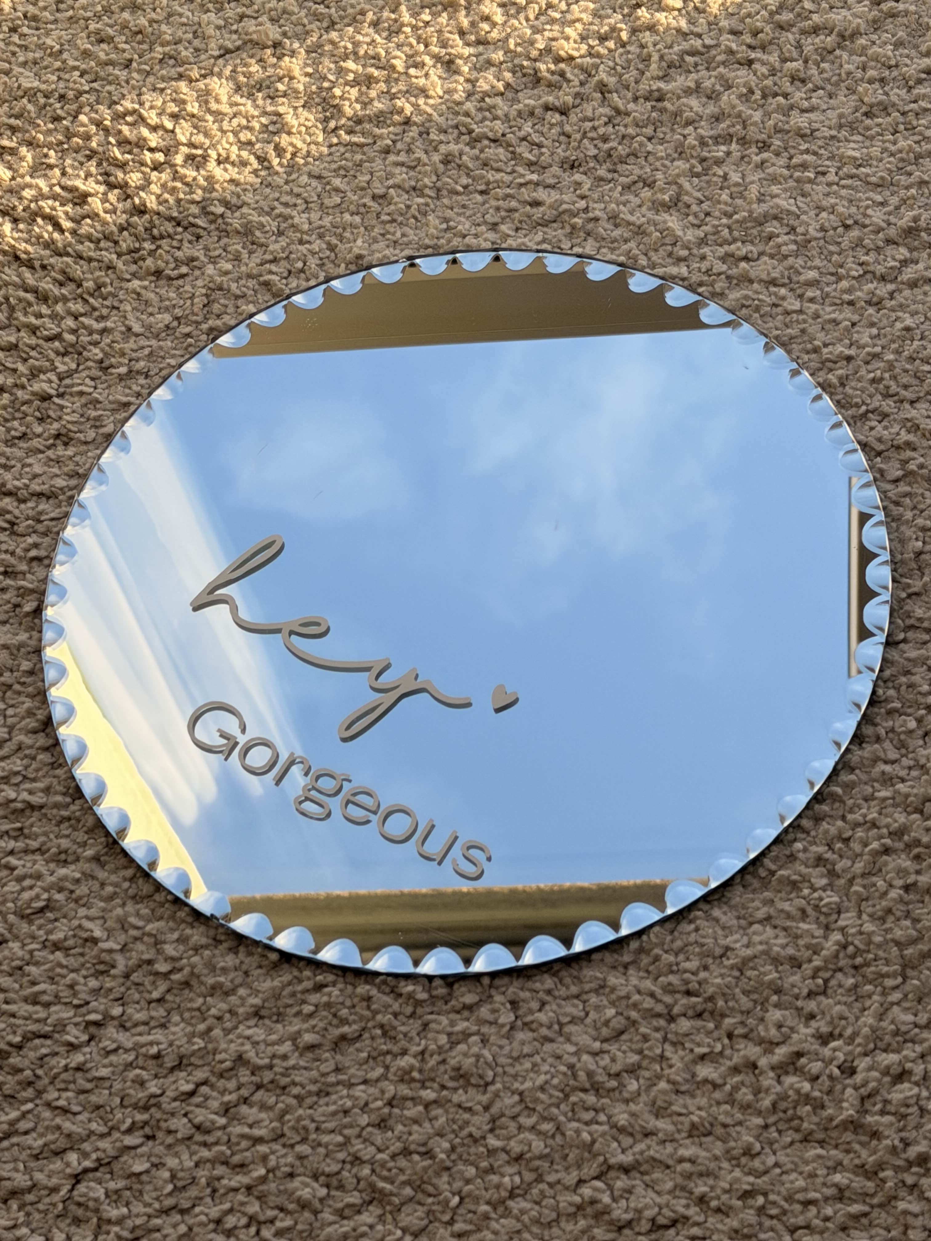 Round mirror with personalised vinyl lettering