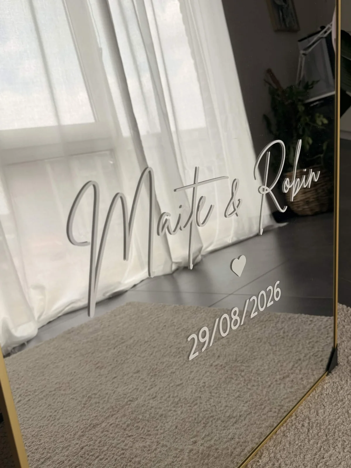 Close-up of names and date lettering on a personalised wedding mirror